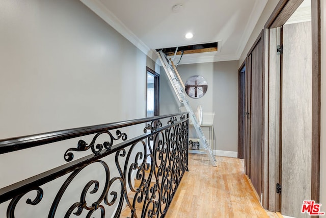 hall with ornamental molding and light hardwood / wood-style floors