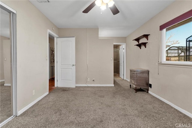 unfurnished bedroom featuring ceiling fan and carpet flooring