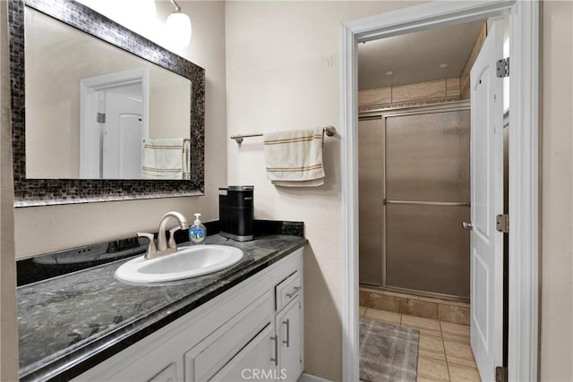 bathroom featuring vanity, tile patterned flooring, and walk in shower