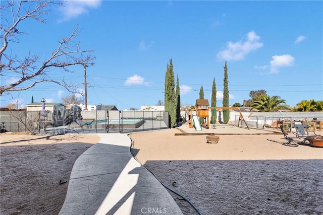 view of yard featuring a playground and a swimming pool