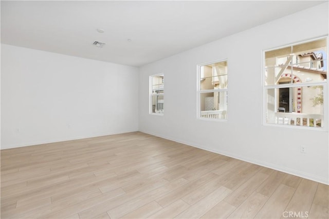 unfurnished room with light hardwood / wood-style flooring