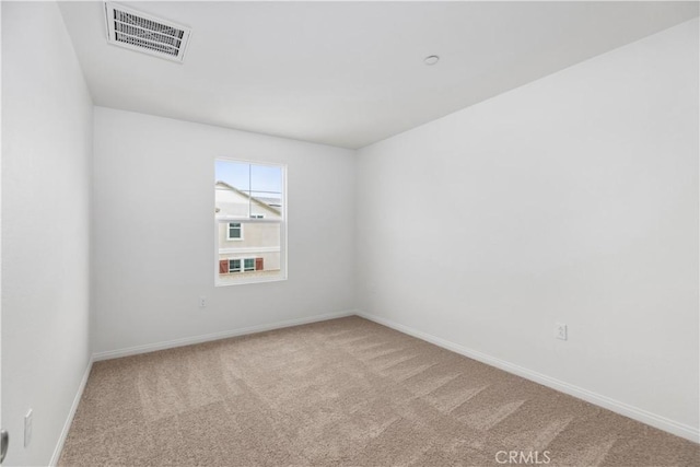 spare room with light colored carpet