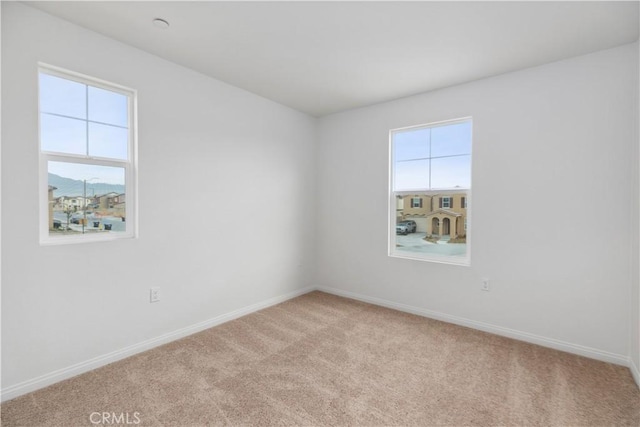 unfurnished room with light colored carpet