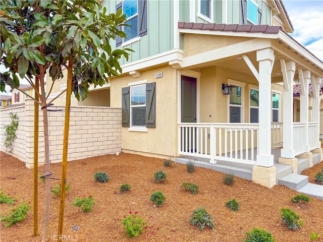 view of side of home with covered porch