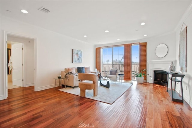 living room featuring crown molding and light wood-type flooring