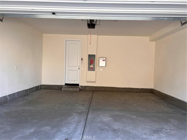 garage with electric panel and a garage door opener