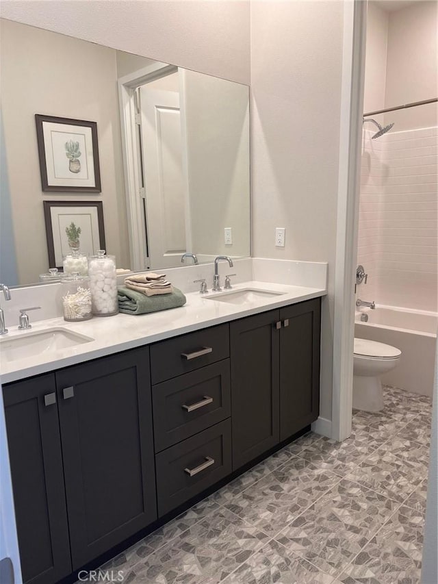 full bathroom featuring toilet, vanity, and shower / bathtub combination