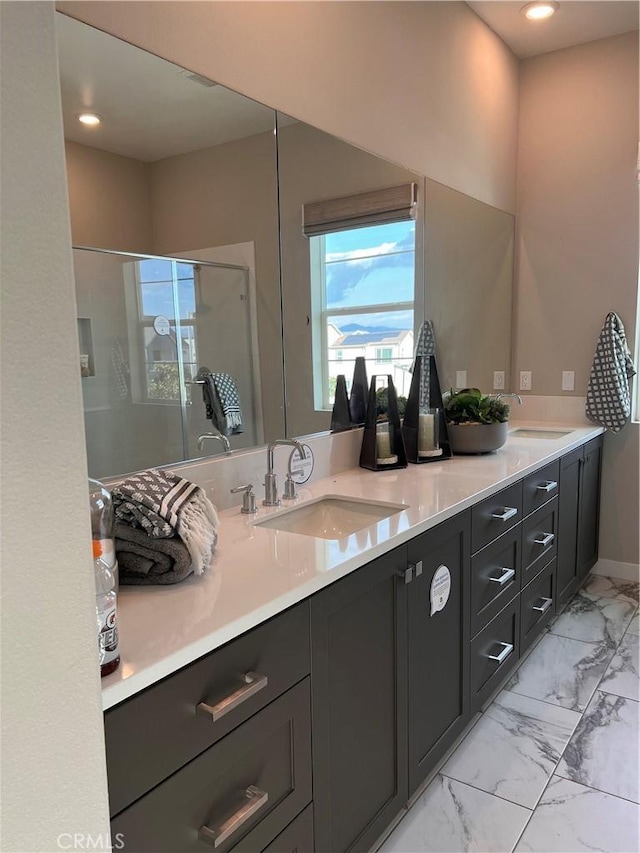 bathroom featuring an enclosed shower and vanity