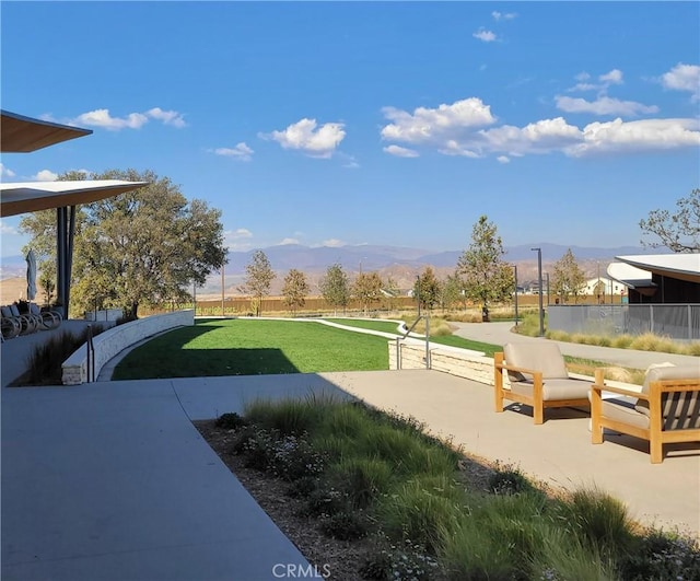 view of home's community featuring a mountain view and a yard