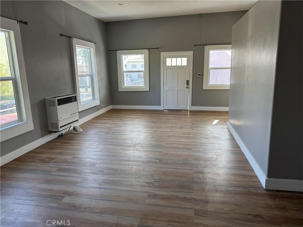 entryway with hardwood / wood-style flooring and heating unit