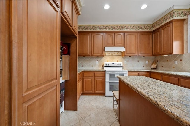 kitchen with range with two ovens, brown cabinets, under cabinet range hood, and light stone countertops