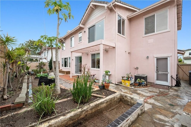 back of house with a patio area, fence, a pergola, and stucco siding