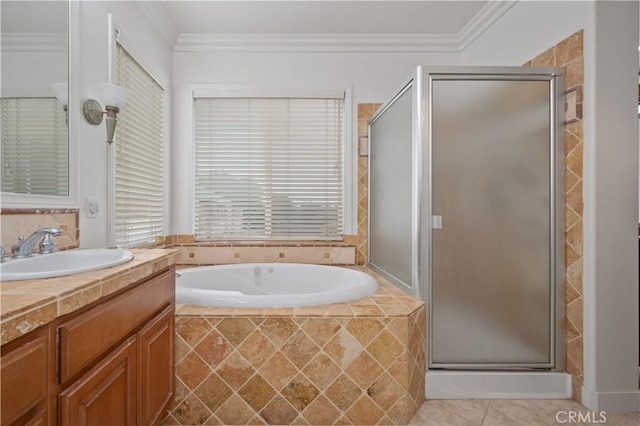 bathroom featuring a stall shower, a garden tub, crown molding, and vanity