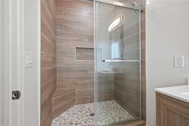 bathroom with a stall shower and vanity