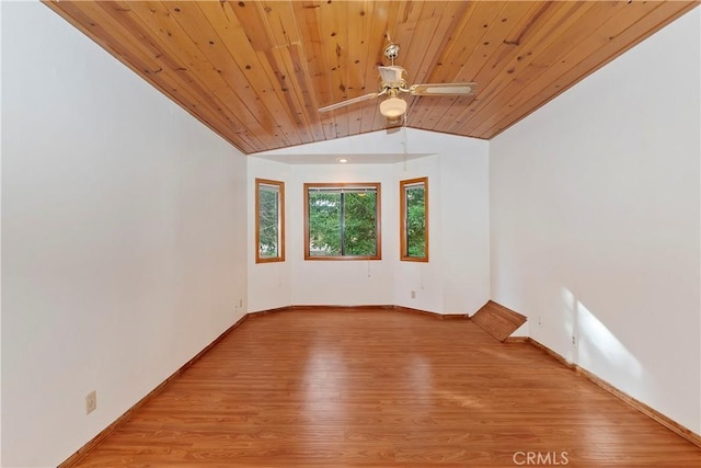 spare room with wooden ceiling, light wood-type flooring, vaulted ceiling, and ceiling fan