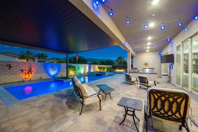 view of pool with an outdoor kitchen, an in ground hot tub, and a patio