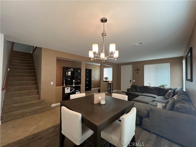 dining space featuring a notable chandelier