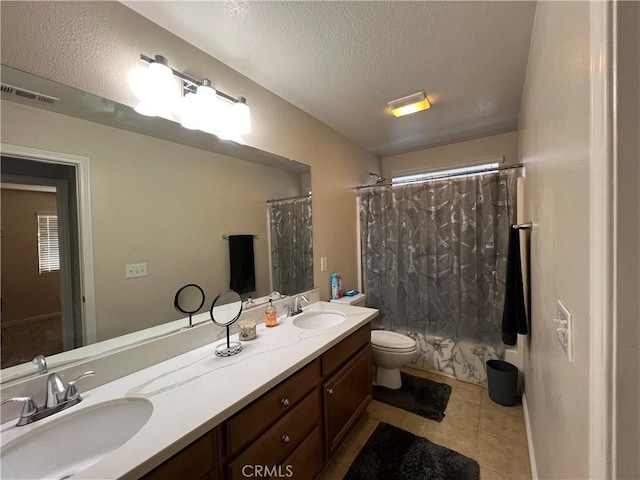 full bathroom featuring toilet, vanity, tile patterned floors, shower / tub combo, and a textured ceiling