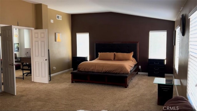 carpeted bedroom with vaulted ceiling and multiple windows