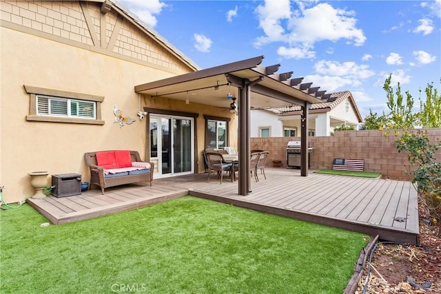 rear view of house with a lawn and a deck