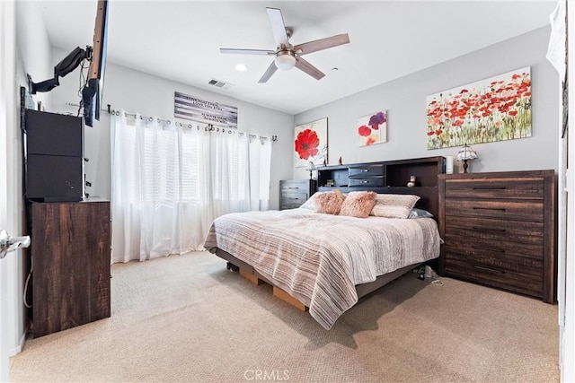 bedroom with ceiling fan and light carpet