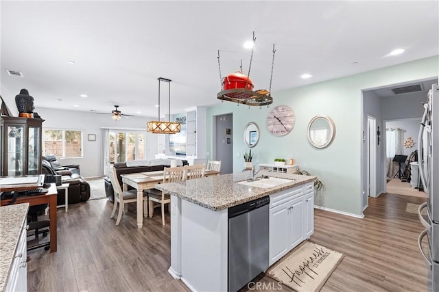 kitchen featuring white cabinets, stainless steel appliances, sink, a kitchen island with sink, and ceiling fan