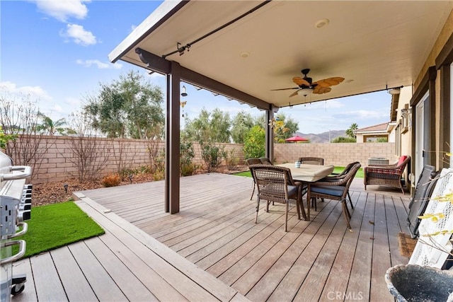 wooden terrace featuring ceiling fan