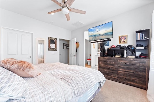 bedroom with connected bathroom, ceiling fan, and light colored carpet