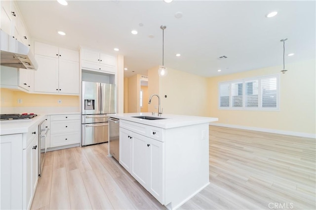 kitchen featuring sink, hanging light fixtures, white cabinets, and stainless steel appliances