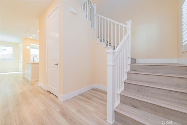 stairs featuring wood-type flooring