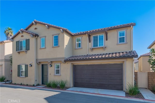 mediterranean / spanish-style home featuring a garage