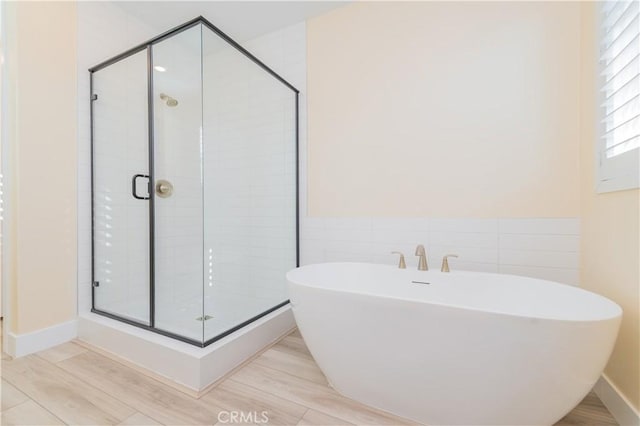 bathroom featuring shower with separate bathtub