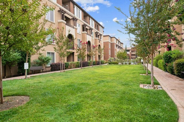 view of home's community featuring a lawn