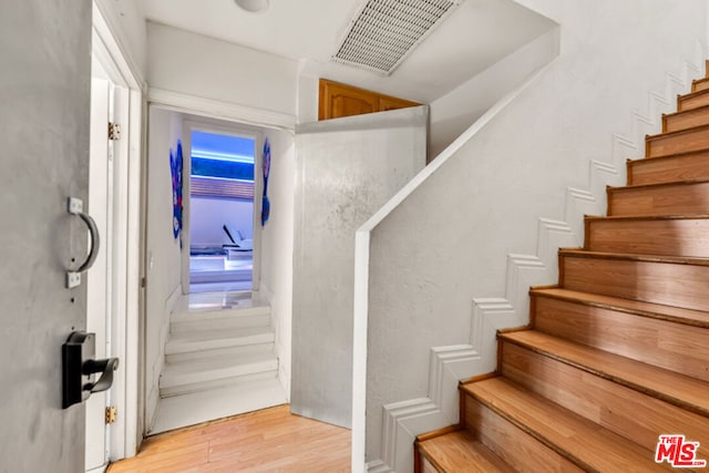 staircase featuring hardwood / wood-style flooring