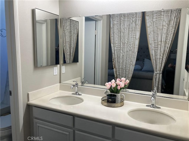 bathroom featuring toilet and vanity