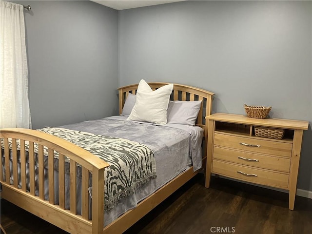 bedroom featuring dark hardwood / wood-style flooring