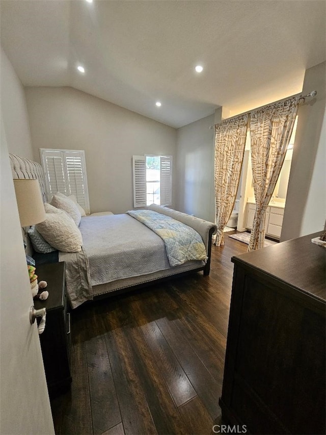 bedroom with vaulted ceiling and dark wood-type flooring