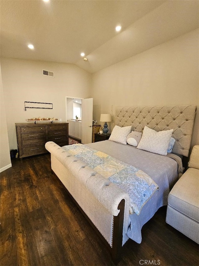 bedroom with vaulted ceiling and dark hardwood / wood-style floors