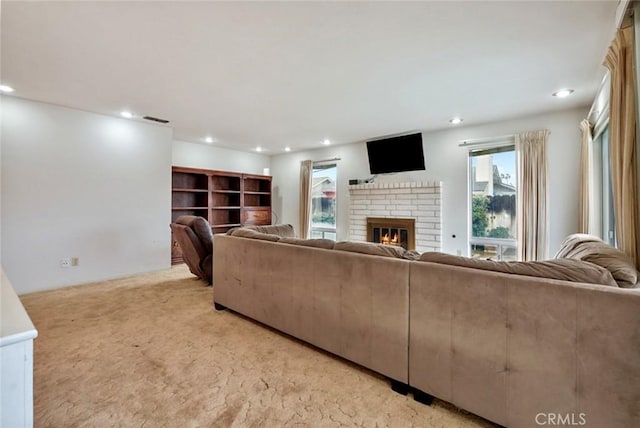 carpeted living room featuring a fireplace