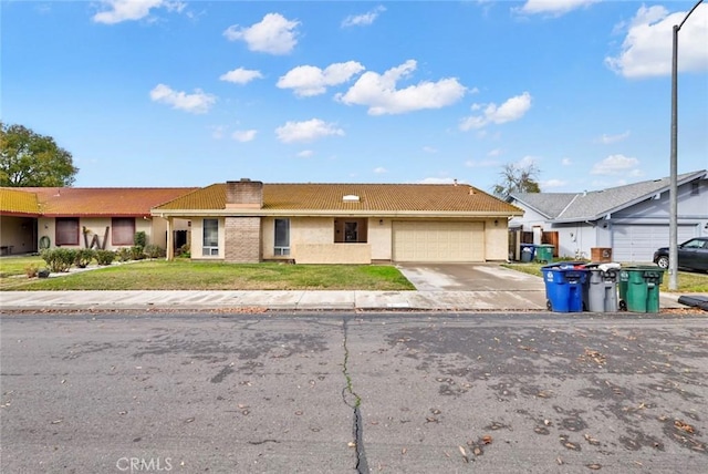 ranch-style house featuring a front yard and a garage