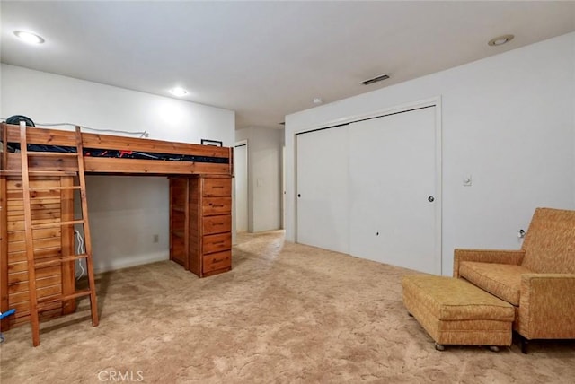 bedroom featuring a closet and carpet flooring