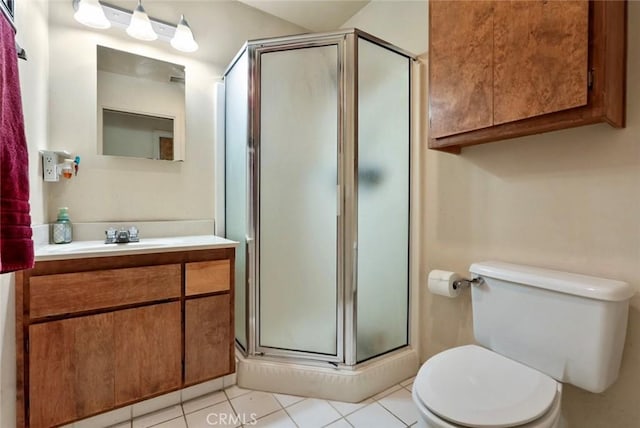 bathroom featuring tile patterned floors, walk in shower, toilet, and vanity