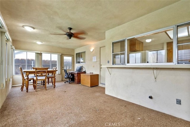 office space featuring ceiling fan and light carpet