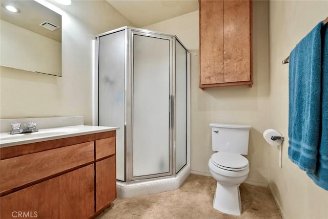 bathroom with toilet, walk in shower, and vanity