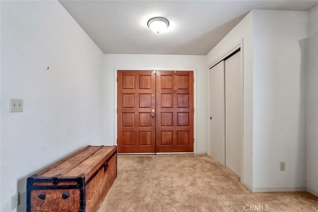 entryway featuring light carpet