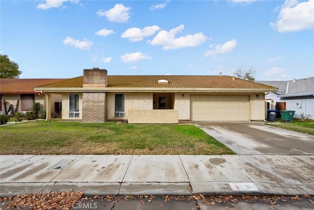 ranch-style home featuring a front lawn and a garage