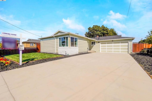 ranch-style home with a garage and a front lawn