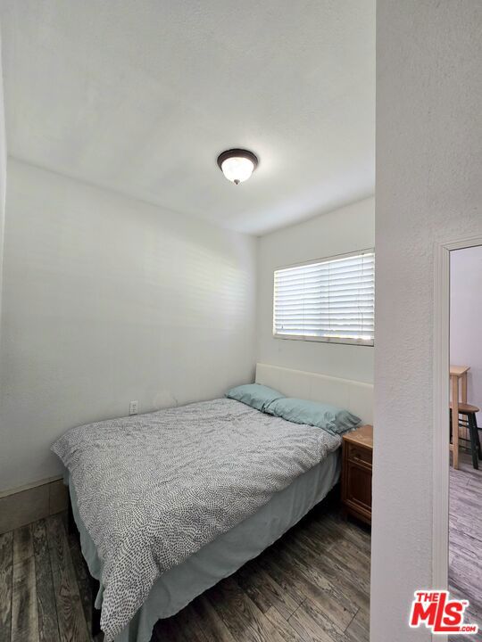 bedroom featuring dark hardwood / wood-style flooring