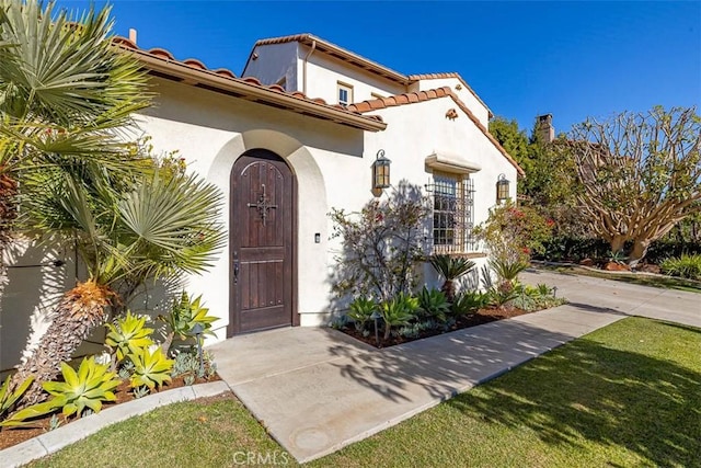 entrance to property with a yard