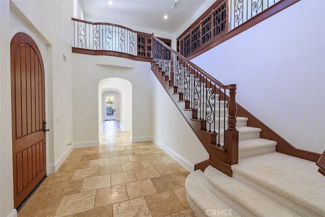 foyer entrance featuring a towering ceiling